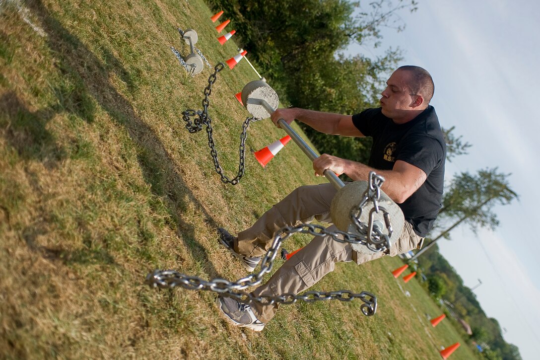 Sgt. Bryan Melius, Marine Barracks Washington, Guard Company, lifts a weighted bar in a clean and press event during the Third Annual Iron Team Endurance Competition in Laurel, Md., Sept. 26. Guard Co. sent two teams of four Marines to the competition, which included various strength and conditioning challenges, a three-mile trail run, and a mile-long boat paddle. The company’s second team finished in fourth place out of 29 teams from various police organizations across the east coast.
