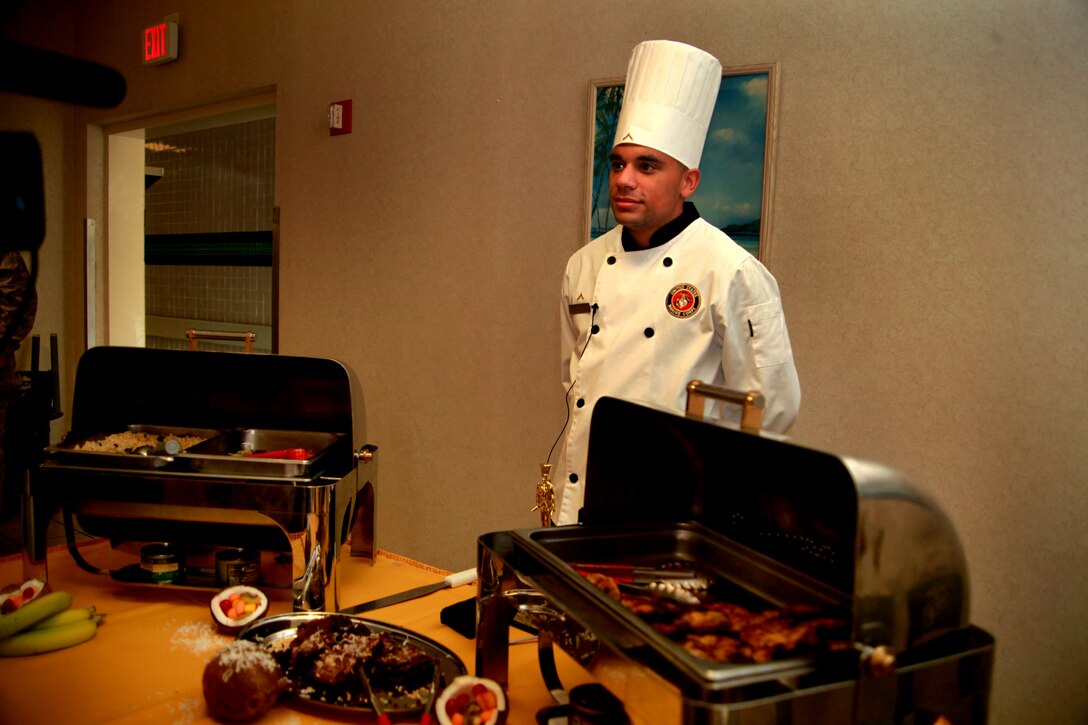 MARINE CORPS AIR STATION CHERRY POINT, N.C. – Pfc. Wesley Overholtzer, a food service specialist with Marine Wing Support Squadron 274, presents his meal to attendees of the Chef of the Quarter competition at the Cherry Point Mess Hall Sept. 20. Overholtzer won first place with his Jamaican-style chicken and rice ensemble, a meal inspired by a friend who died in an automobile accident two years ago.
