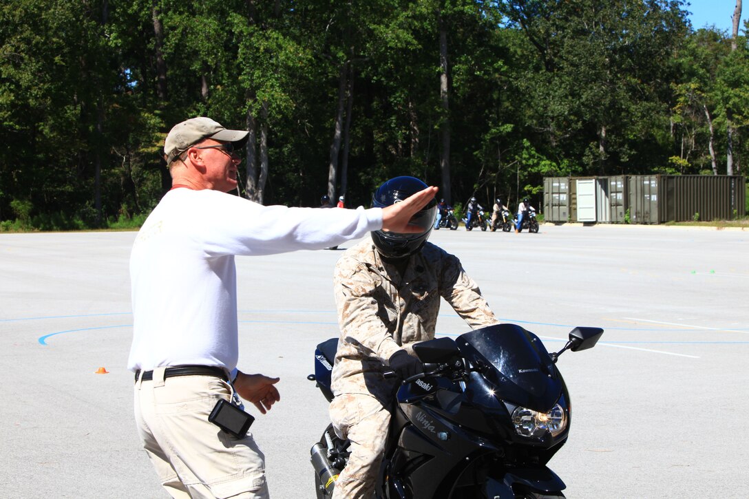 Mike Lacy, a motorcycle rider-coach aboard Camp Lejeune, N.C., teaches a student the finer points of motorcycle operation during the Basic Rider’s Course Sept. 24, 2012. Lacy and his wife, Elaine, have roughly 50 years of motorcycle riding experience together and have dedicated their lives to keeping fellow riders safe on the roads. (U.S. Marine Corps photo by Lance Cpl. Paul Peterson)