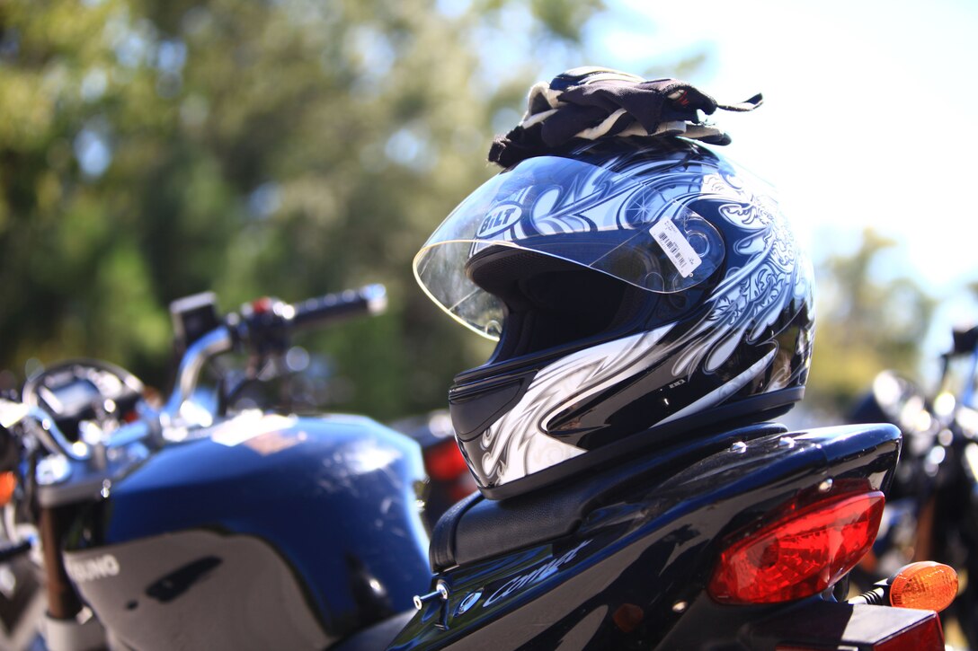 A pair of gloves and a Department of Transportation-approved helmet sit atop a training motorcycle before the Basic Rider’s Course aboard Camp Lejeune; N.C.; Sept. 24; 2012.; In order to ride a motorcycle and be compliant with Marine Corps order that governs motorcycle riders; Marines and sailors must wear proper protective equipment at all times while riding. (U.S. Marine Corps photo by Lance Cpl. Paul Peterson)