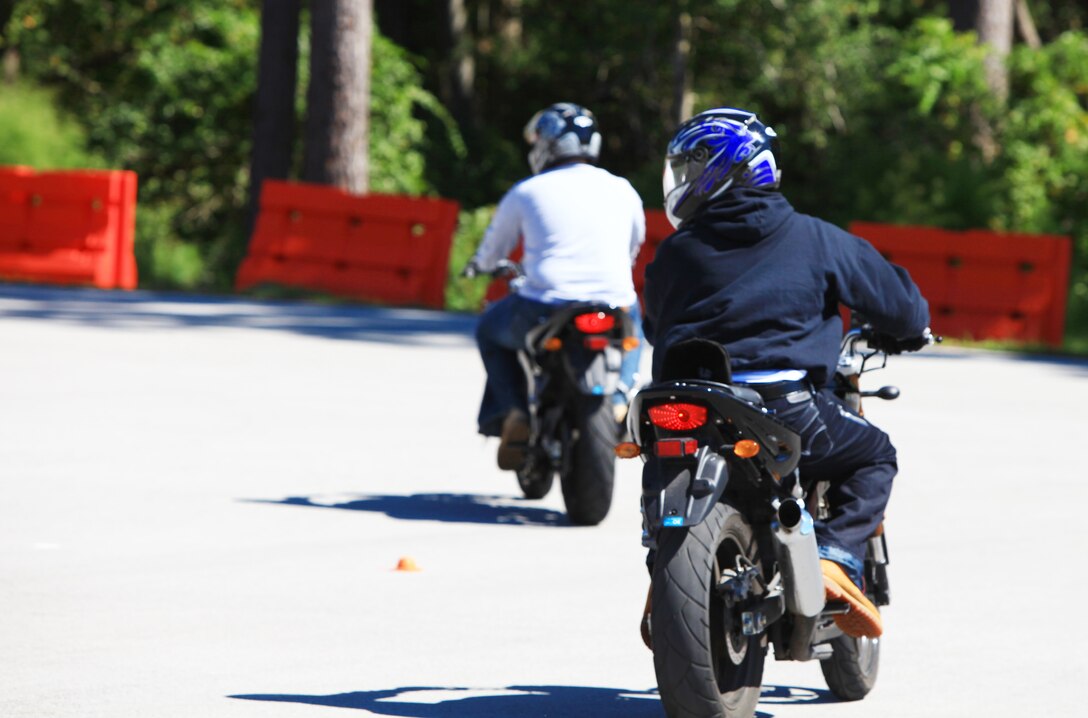 Two Marines, each motorcycle safety students, navigate a left turn as part of Basic Rider’s Course aboard Camp Lejeune, N.C., Sept. 24, 2012.  The BRC is a two-day course, is free to active-duty military personnel, and teaches the basic fundamentals of motorcyle operation and safety. (U.S. Marine Corps photo by Lance Cpl. Paul Peterson)