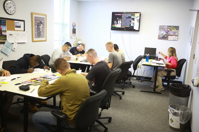 Servicemembers with II Marine Expeditionary Force answer questions from a motrocyle safety handbook during the classroom portion of the Basic Rider’s Course aboard Camp Lejeune, N.C., Sept. 24, 2012. The BRC is a two-day course, is free to active-duty military personnel, and teaches the basic fundamentals of motorcyle operation and safety.  (U.S. Marine Corps photo by 1st Lt. James F. Stenger)