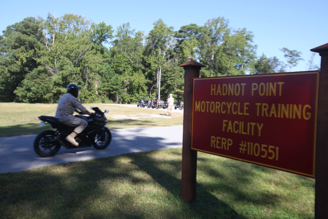A motorcycle student rides past the entrance to the Hadnot Point Motorcycle Training Facility aboard Camp Lejeune, N.C., Sept. 24, 2012, on his way to completing the Basic Rider’s Course. In order to ride a motorcycle and be compliant with Marine Corps order that governs motorcycle riders, Marines and sailors must complete the BRC and other follow-on training. (U.S. Marine Corps photo by 1st Lt. James F. Stenger)