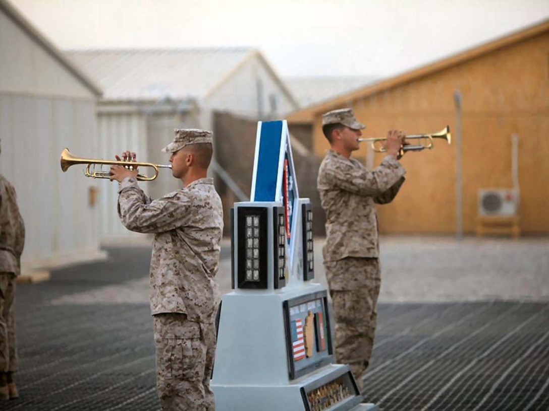 CAMP LEATHERNECK, Helmand province, Islamic Republic of Afghanistanâ€” Staff Sgt. Mark Reheard and Sgt. Jason Comfort, from the 1st Marine Division (Forward) band, played â€œTapsâ€ during a Colors and Memorial ceremony at Camp Leatherneck, Helmand province, Afghanistan, Oct. 10, 2010. (Official US Marine Corps photo by Cpl. Skyler Tooker)