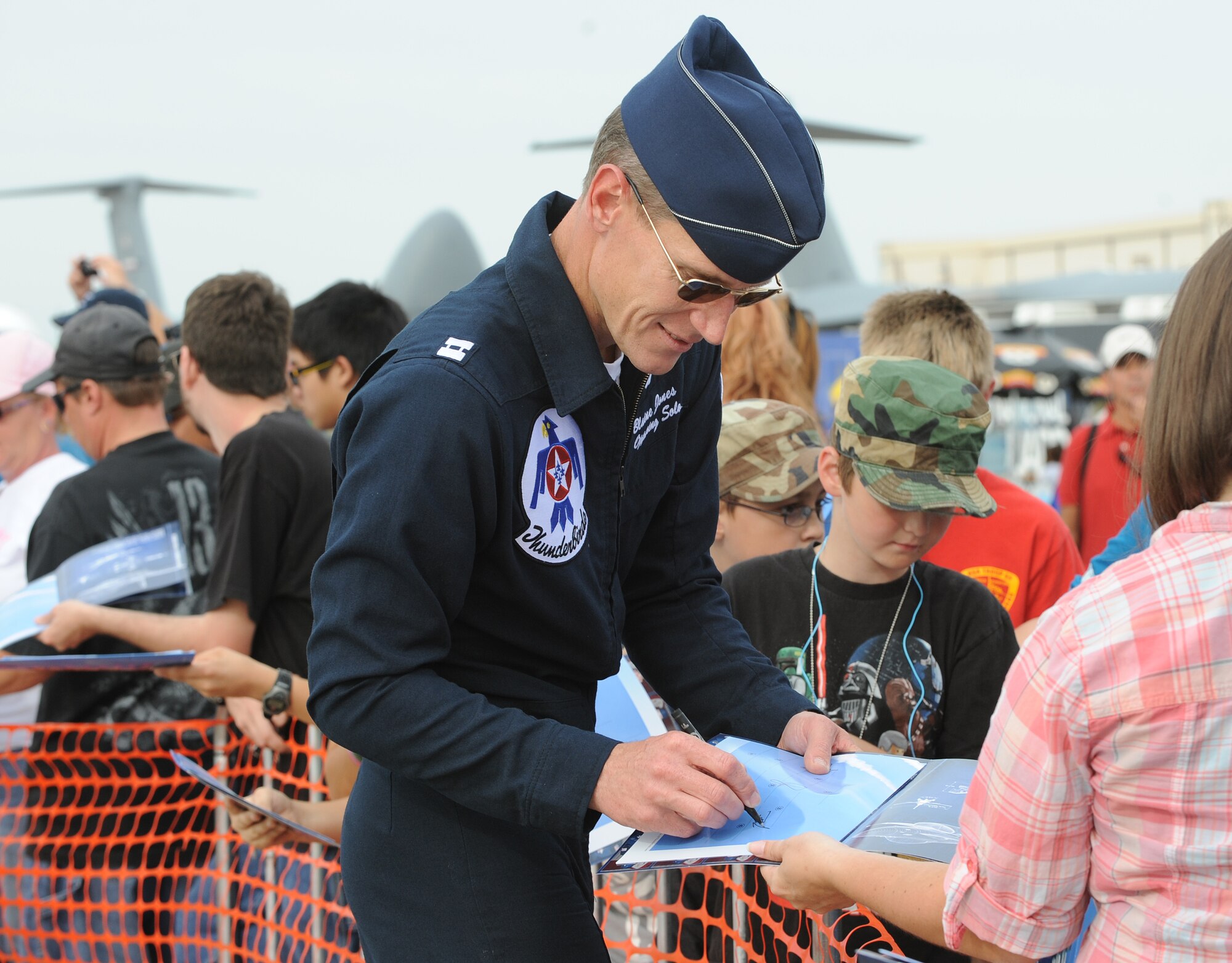 Capt. Blaine Jones, U.S. Air Force Thunderbirds opposing solo pilot, signs autographs for air show attendees Sept. 29, 2012, McConnell Air Force Base, Kan.  Jones entered the Air Force in 2002 from Officer Training School after graduating from Kansas State University in 1996. (U.S Air Force photo/Airman 1st Class Katrina M. Brisbin)
