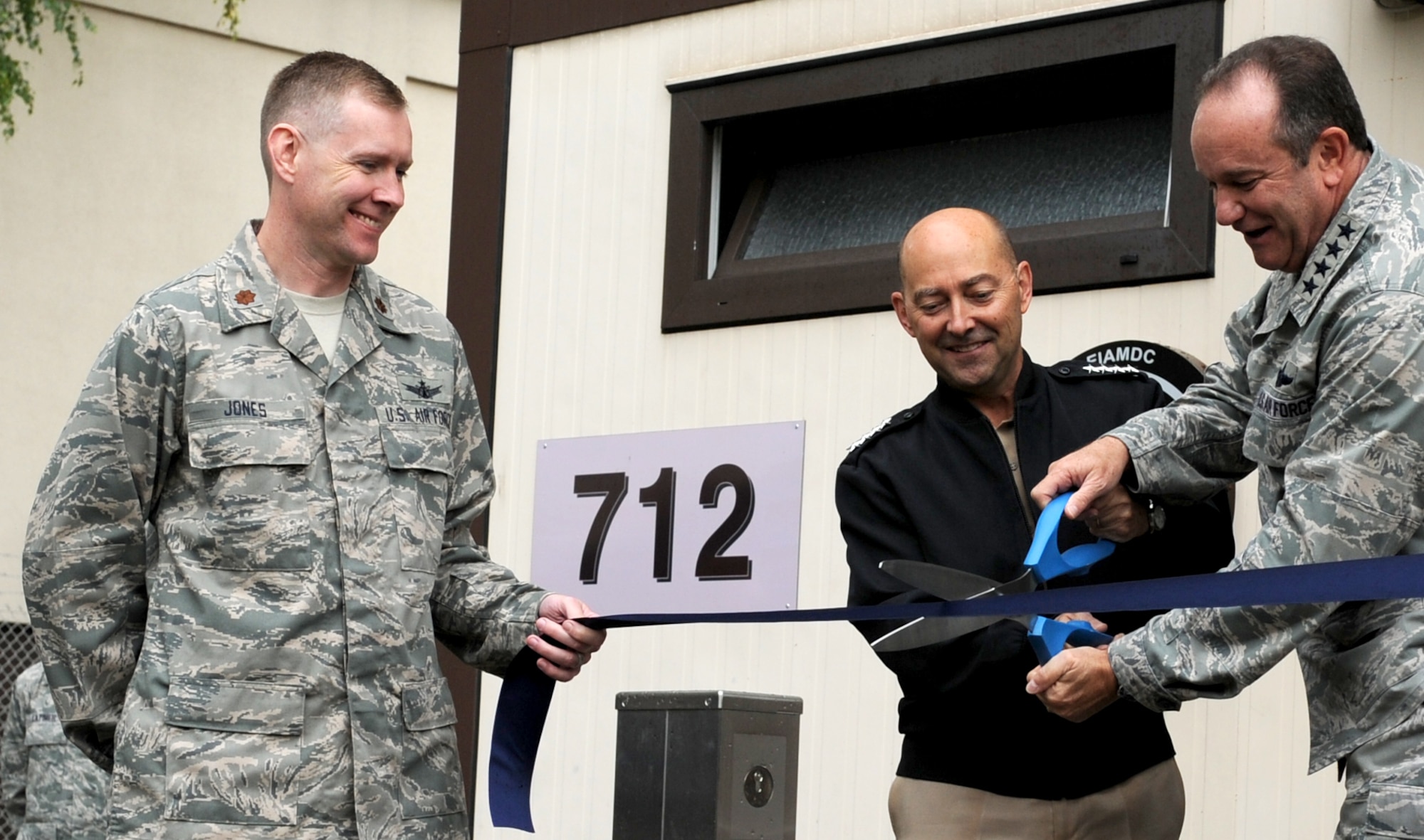 Admiral James Stavridis, Supreme Headquarters Allied Powers Europe commander, (center) and Gen. Philip M. Breedlove, Allied Air Command Ramstein commander, cut the ribbon to the European Integrated Air and Missile Defense Center held by Maj Judson B. Jones, Deputy Director, European Integrated Air & Missile Defense Center during a ceremony Sept. 26, 2012, Einsiedlerhof, Germany. The EIAMDC addresses increased education and training requirements driven by a new approach to missile defense and the emerging NATO territorial ballistic missile defense mission. (U.S. Air Force photo/Capt. William Russell)