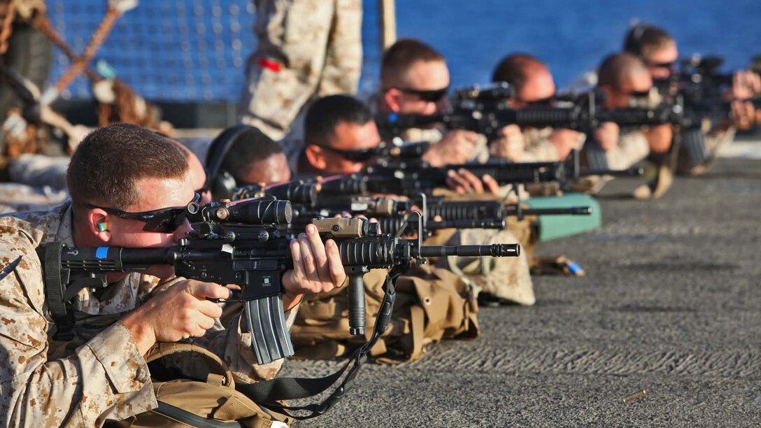 Servicemembers from Combat Logistics Battalion 15, 15th Marine Expeditionary Unit, sight-in on targets on the flight deck of the USS Rushmore, Sept. 27. During the 15th MEU and Peleliu Amphibious Ready Group’s Western Pacific deployment, the Marines and sailors decided to let loose a few rounds in order to find their battle sight zero and ensure their M16A4 and M4A1 service rifles were functioning properly.