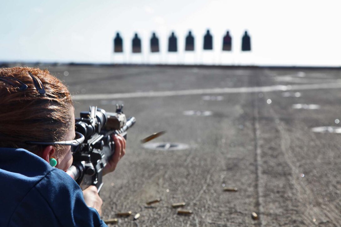 Petty Officer 3rd Class Erin Wolford, culinary specialist, Ship’s Company, USS Rushmore, fires an M4A1 service rifle during a live-fire rifle shoot on the flight deck of the USS Rushmore, Sept. 27. During the 15th MEU and Peleliu Amphibious Ready Group’s Western Pacific deployment, the Marines and sailors decided to let loose a few rounds in order to find their battle sight zero and ensure their M16A4 and M4A1 service rifles were functioning properly. Wolford, 25, is from Bloomingdale, Mich.
