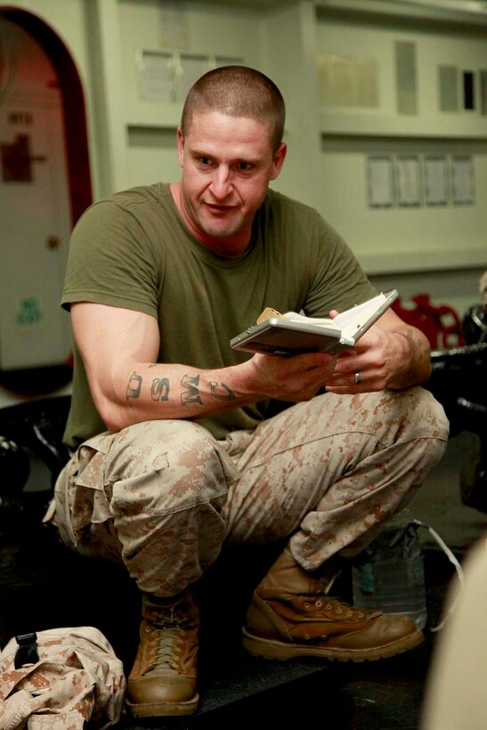 Staff Sgt. Jason J. Morgan, explosive ordnance disposal team leader, 2nd Team, Combat Logistics Battalion 15, 15th Marine Expeditionary Unit, discusses a scripture he read in the bible with his fellow Marines aboard the USS Peleliu, Sept. 27. Marines with Battalion Landing Team 3/5, 15th MEU have recently formed Darkhorse Disciples, a lay-led bible study, aboard the USS Peleliu. While infantry Marines founded the program, servicemembers of any rank or field are welcome to attend. Morgan, 35, is from Cleveland, Tenn.