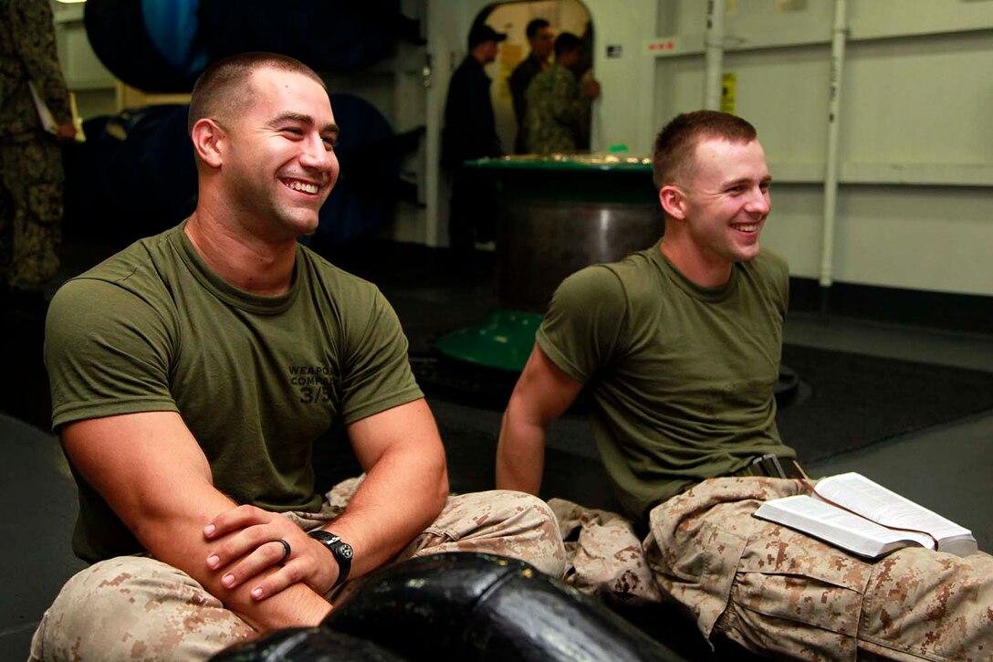 Sergeant Scott W. Gilchrist (left), Tactical Recovery of Aircraft and Personnel team leader, and Cpl. Mark N. Sherfy, squad leader, both with 81mm Mortar/TRAP Platoon, Weapons Company, Battalion Landing Team 3/5, 15th Marine Expeditionary Unit, share a laugh during a bible study aboard the USS Peleliu, Sept. 27. Marines with BLT 3/5, 15th MEU have recently formed Darkhorse Disciples, a lay-led bible study, aboard the USS Peleliu. While infantry Marines founded the program, servicemembers of any rank or field are welcome to attend. Gilchrist, 24, is from Ft. Worth, Texas, and Sherfy, 24, is from Bakersfield, Calif.