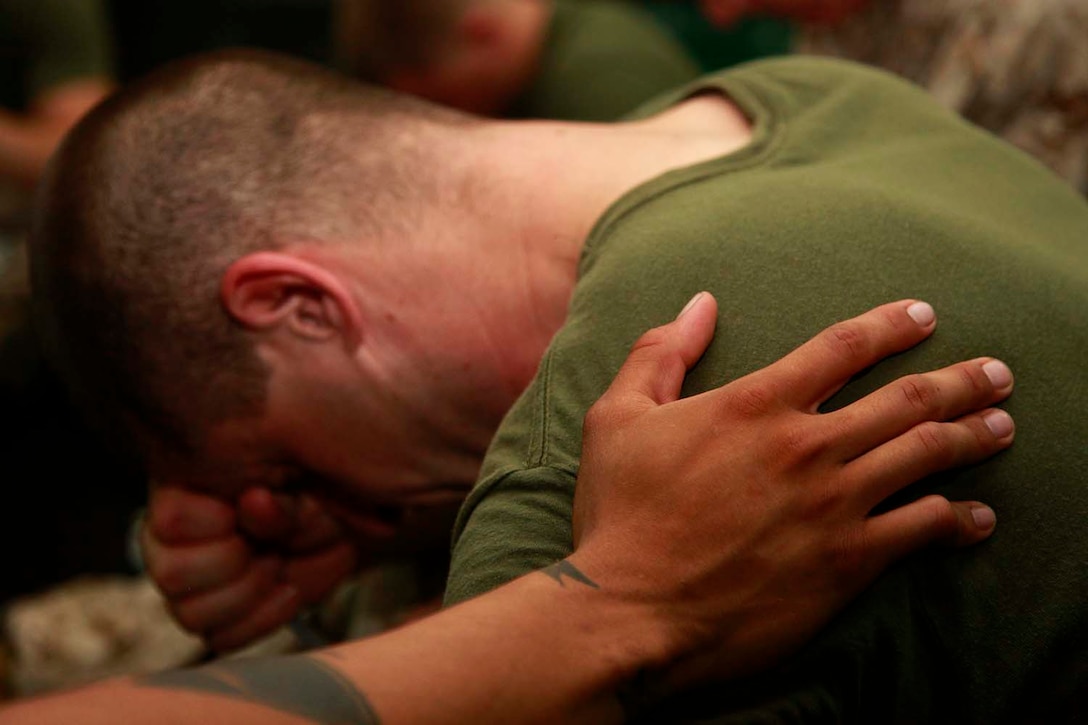 A Marine with the 15th Marine Expeditionary Unit comforts a Marine during a bible study aboard the USS Peleliu, Sept. 27. Marines with Battalion Landing Team 3/5, 15th MEU have recently formed Darkhorse Disciples, a lay-led bible study, aboard the USS Peleliu. While infantry Marines founded the program, servicemembers of any rank or field are welcome to attend. Morgan, 35, is from Cleveland, Tenn.