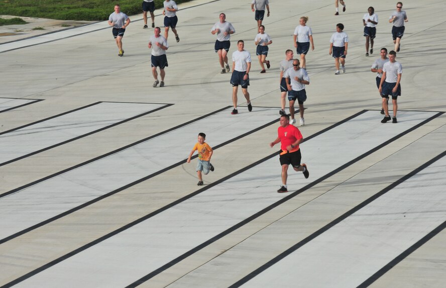 ANDERSEN AIR FORCE BASE, Guam - Members of Team Andersen and their families participate in the monthly wing run here, Sept. 28. This month’s wing run was approximately 3.5 miles and was followed by a foreign object debris walk on the flightline. These events are held to emphasize physical fitness and esprit de corps throughout the Team Andersen community.  (U.S. Air Force photo by Staff Sgt. Alexandre Montes)
