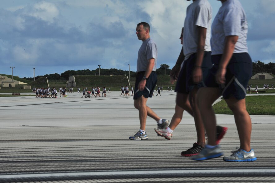 ANDERSEN AIR FORCE BASE, Guam - Members of Team Andersen and their families participate in a foreign object debris walk after the monthly wing run here, Sept. 28. This month’s wing run was approximately 3.5 miles and was followed by a FOD walk on the flightline. These events are held to emphasize physical fitness and esprit de corps throughout the Team Andersen community.  (U.S. Air Force photo by Staff Sgt. Alexandre Montes)