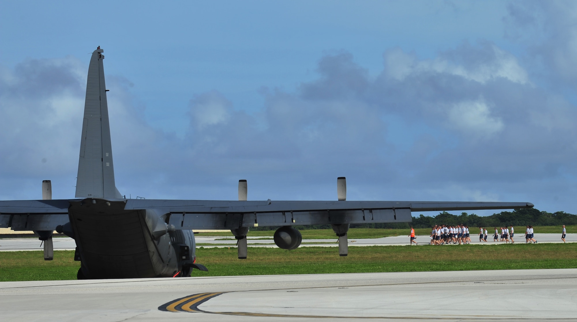 ANDERSEN AIR FORCE BASE, Guam - Members of Team Andersen and their families participate in a foreign object debris walk after the monthly wing run here, Sept. 28. This month’s wing run was approximately 3.5 miles and was followed by a FOD walk on the flightline. These events are held to emphasize physical fitness and esprit de corps throughout the Team Andersen community.  (U.S. Air Force photo by Staff Sgt. Alexandre Montes)