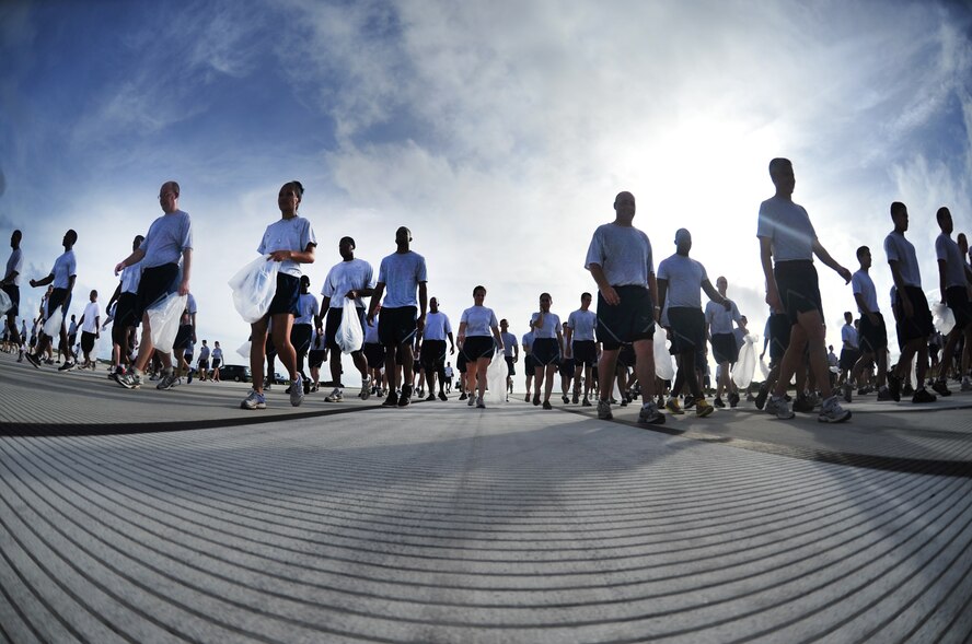 ANDERSEN AIR FORCE BASE, Guam - Members of Team Andersen and their families participate in a foreign object debris walk after the monthly wing run here, Sept. 28. This month’s wing run was approximately 3.5 miles and was followed by a FOD walk on the flightline. These events are held to emphasize physical fitness and esprit de corps throughout the Team Andersen community.  (U.S. Air Force photo by Staff Sgt. Alexandre Montes)