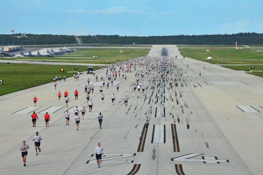ANDERSEN AIR FORCE BASE, Guam –Members of Team Andersen and their families participate in the monthly wing run here, Sept. 28. This month’s wing run was approximately 3.5 miles and was followed by a foreign object debris walk on the flightline. These events are held to emphasize physical fitness and esprit de corps throughout the Team Andersen community.  (U.S. Air Force photo by Staff Sgt. Alexandre Montes)