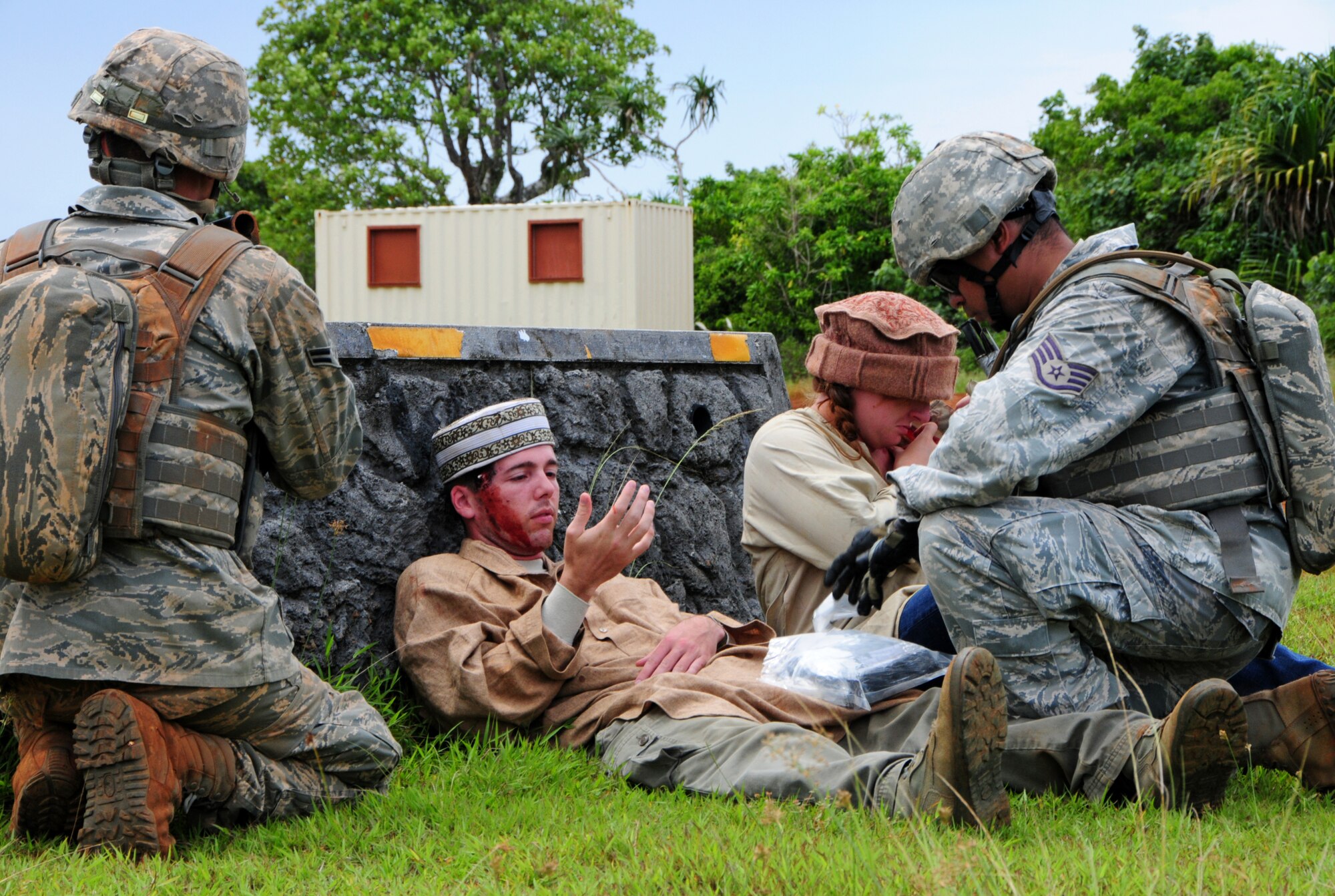 PACIFIC REGIONAL TRAINING CENTER, Guam – Commando Warrior students from Kadena AFB, Japan, conduct self aid and buddy care on a foreign national with a head injury and another with a chest wound during contingency training here, Sept. 24. Security forces Airmen from all over the Pacific travel to Guam in order to receive mandatory contingency training from the 736th Security Forces Squadron Commando Warrior flight in preparation for future deployments downrange. (U.S. Air Force photo by Airman 1st Class Marianique Santos/Released)