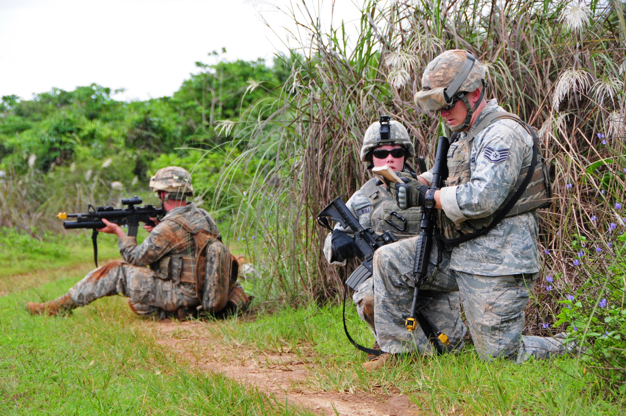 PACIFIC REGIONAL TRAINING CENTER, Guam – Commando Warrior fire team leaders discuss and note information regarding events and details on the opposing forces during a simulated encounter with the insurgents here, Sept. 24. Security forces Airmen from all over the Pacific travel to Guam in order to receive mandatory contingency training from the 736th Security Forces Squadron Commando Warrior flight in preparation for future deployments downrange. (U.S. Air Force photo by Airman 1st Class Marianique Santos/Released)