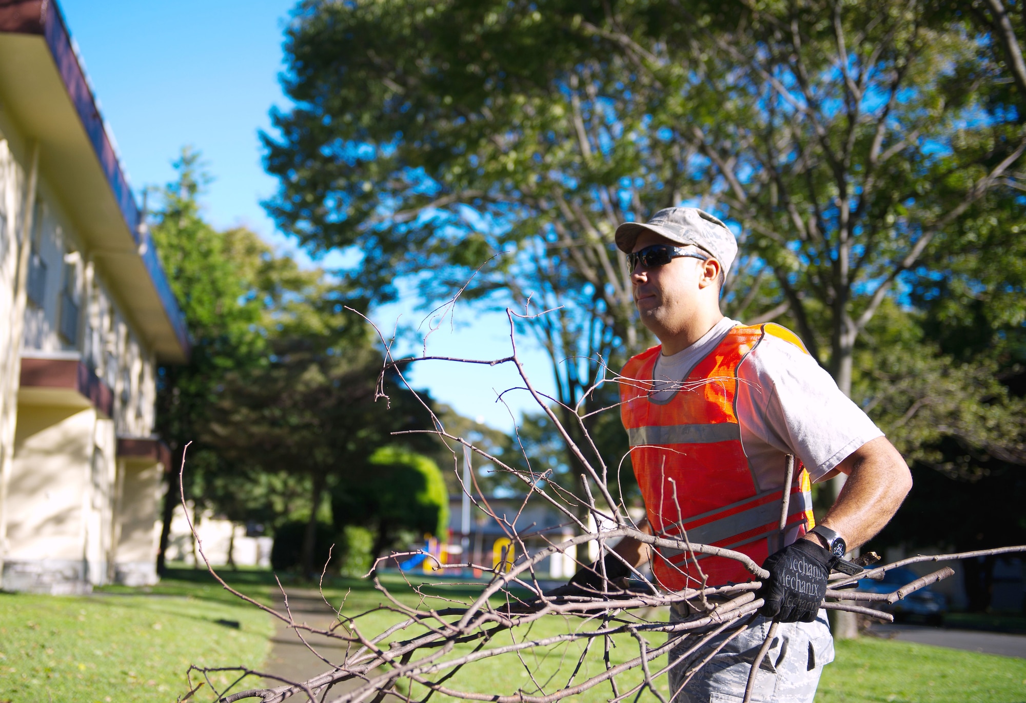 YOKOTA AIR BASE, Japan -- Staff Sgt. Jonathan Pittman, 374th Civil Engineer Squadron utilities specialist, picks up fallen tree branches during the recovery phase of Typhoon Jelawat at Yokota Air Base, Japan, on Oct. 1, 2012. Once high wind speeds subsided, recovery crews were sent out to assess and repair damages. (U.S. Air Force photo by Staff Sgt. Chad C. Strohmeyer)