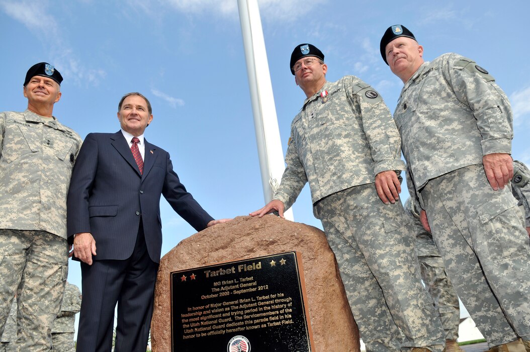 The Adjutant General of the Utah National Guard, Jefferson S. Burton (left), Utah Governor Gary Herbert, Maj. Gen. Brian Tarbet and Command Sgt. Maj. Micheal Miller pose by the newly dedicated monumet to Tarbet on the occasion of his retirement from service as the Utah Adjutant General at Camp Williams Utah, Sept. 28 2012. (Air Force Photo by TSgt. Jeremy Giacoletto-Stegall/Released)