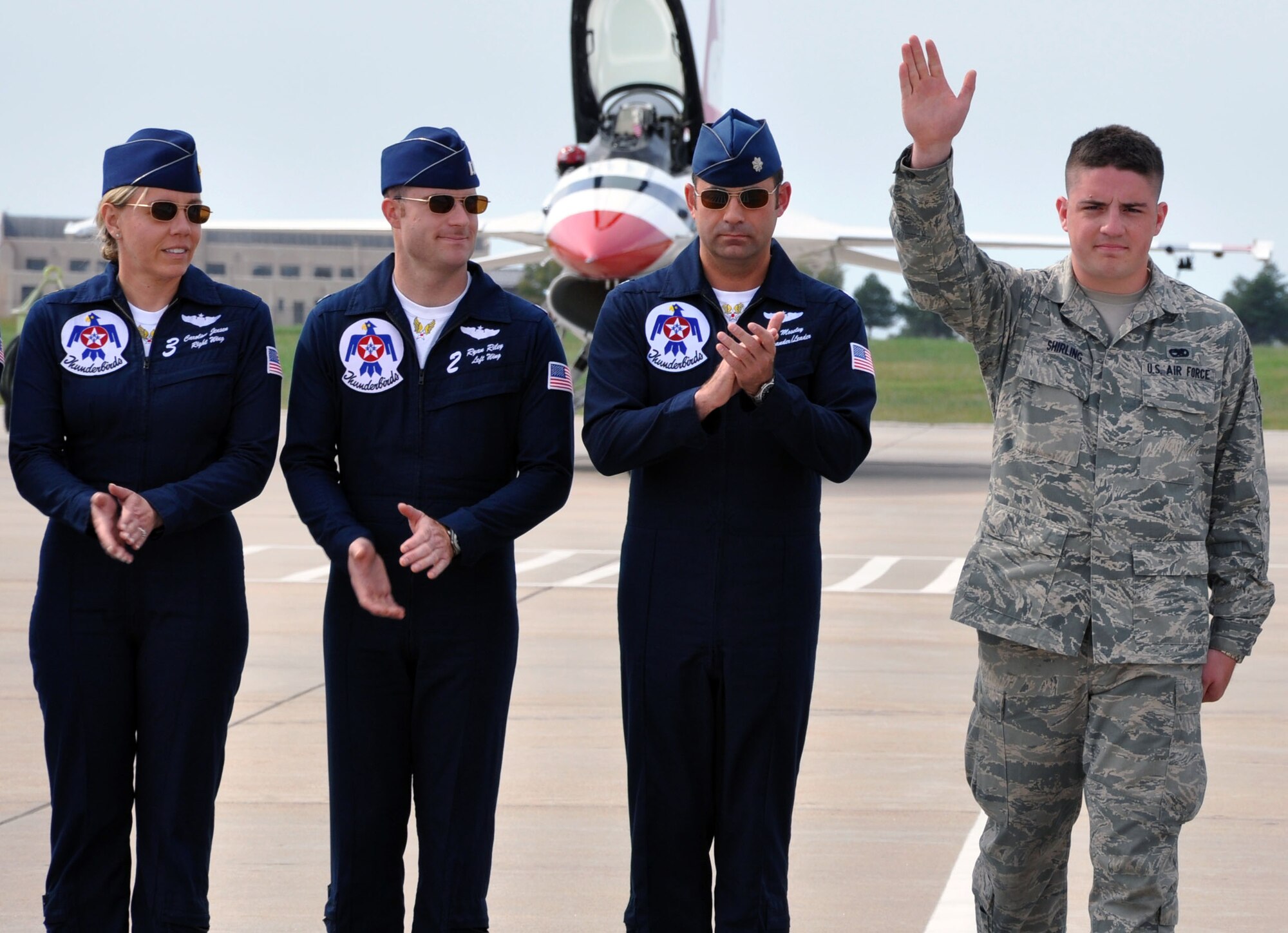 Senior Airman Andrew Shirling, a crew chief assigned to the Air Force Reserve 931st Air Refueling Group, waves to the crowd while being recognized for outstanding achievement at the "Wings Over McConnell" air show at McConnell Air Force Base, Kan., Sept. 30, 2012.  Shirling, a traditional Reservist, was one of five members of Team McConnell recognized by the U.S. Air Force Thunderbirds F-16 demonstration squadron prior to the team's performance.  (U.S. Air Force photo by 1st Lt. Zach Anderson)