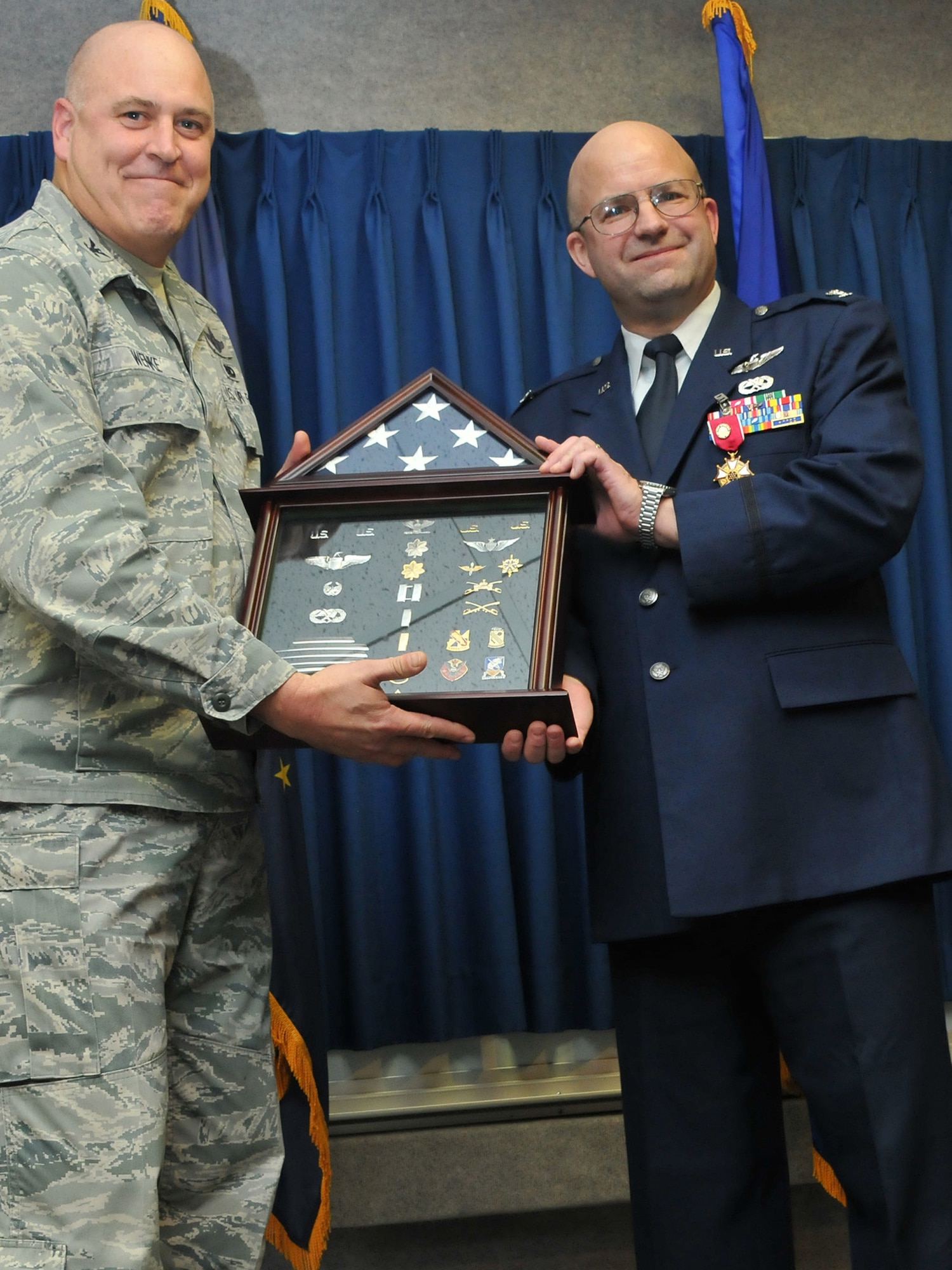 JOINT BASE ELMENDORF-RICHARDSON, Alaska - Col. Robert A. K. Doehl, the 176 Wing vice commander, celebrates his retirement here Sep. 23. Doehl is presented a shadow box. This gift is a traditional display symbolizing a member's military accomplishments. Alaska Air National Guard photo by Staff Sgt. N. Alicia Goldberger