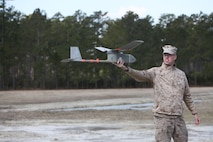 : Pfc. John D. Duydos, a Marine with Combat Logistics Battalion 6, 2nd Marine Logistics Group, displays the portability of a Raven unmanned aerial vehicle and ease of launch in a field aboard Camp Lejeune, N.C., March 26, 2013. Duydos was among the Marines who volunteered to train on the UAV system. (U.S. Marine Corps photo by Lance Cpl. Shawn Valosin)