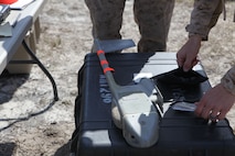 Marines with Combat Logistics Battalion 6, 2nd Marine Logistics Group, make adjustments to a Raven unmanned aerial vehicle aboard Camp Lejeune, N.C., March 26, 2013.  With a weight of four pounds and length of three feet, the UAV can be taken and deployed in a variety of locations. (U.S. Marine Corps photo by Lance Cpl. Shawn Valosin)