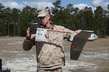 Pfc. John D. Duydos, a Marine with Combat Logistics Battalion 6, 2nd Marine Logistics Group, attaches a tail stabilizer after making some pre-launch adjustments to a Raven unmanned aerial vehicle aboard Camp Lejeune, N.C., March 26, 2013. Duydos was part of a group of Marines who volunteered to train with the Raven system in preparation for an upcoming deployment. (U.S. Marine Corps photo by Lance Cpl. Shawn Valosin)