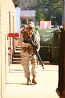 A rear-security guard protects the flank of a fire team during a training exercise held by 2nd Maintenance Battalion, 2nd Marine Logistics Group aboard Camp Lejeune, N.C., March 27, 2013. More than one dozen Marines posing as terrorists infiltrated the battalion’s compound, sparking a pitched battle with the servicemembers as they fought to reclaim the facility. 