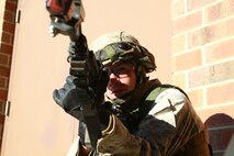 A Marine provides cover for his fire team during a training exercise held by 2nd Maintenance Battalion, 2nd Marine Logistics Group aboard Camp Lejeune, N.C., March 27, 2013. Moments after taking up a defensive position, the fire team received word its way was blocked by enemy activity.