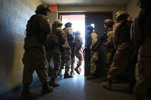 Two Marine fire teams race through a doorway at 2nd Maintenance Battalion, 2nd Marine Logistics Group’s compound aboard Camp Lejeune, N.C., March 27, 2013. The servicemembers spent more than an hour engaging their peers in simulated urban combat during a training exercise held at the base.
