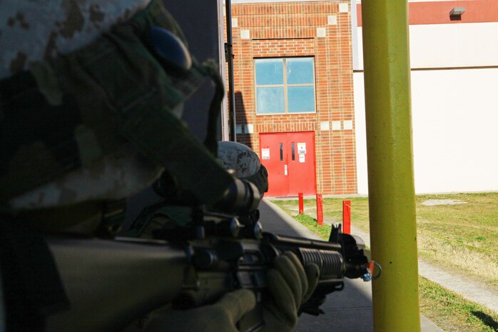 A Marine with 2nd Maintenance Battalion, 2nd Marine Logistics Group takes cover with his squad after the discovery of a simulated improvised explosive device during a training exercise aboard Camp Lejeune, N.C., March 27, 2013. The battalion spent the day conducting counter-terrorist exercises at its facility. 