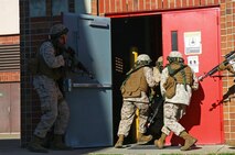 Marines storm through a door during a training exercise held by 2nd Maintenance Battalion, 2nd Marine Logistics Group aboard Camp Lejeune, N.C., March 27, 2013. The unit’s personnel assaulted the compound for more than an hour before eliminating the simulated terrorist threat.