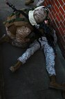 A Marine treats a simulated casualty during a training exercise held by 2nd Maintenance Battalion, 2nd Marine Logistics Group aboard Camp Lejeune, N.C., March 27, 2013. The battalion conducted a series of realistic combat simulations to better prepare its Marines for possible threats. 