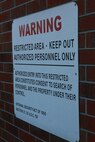 A sign posted at 2nd Maintenance Battalion, 2nd Marine Logistics Group’s compound aboard Camp Lejeune, N.C., warns trespassers to stay off the property. The battalion launched a series of training exercises to counter simulated terrorist attacks March 27, 2013.
