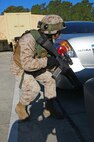 A Marine cautiously makes his way through a parking lot during a simulated terrorist attack at 2nd Maintenance Battalion, 2nd Marine Logistics Group’s compound aboard Camp Lejeune, N.C., March 27, 2013. The battalion’s servicemembers spent more than an hour engaging their peers in simulated urban combat during the training exercise. 