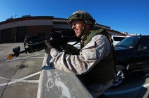 A Marine catches his breath after rushing across a parking lot during a training exercise held by 2nd Maintenance Battalion, 2nd Marine Logistics Group aboard Camp Lejeune, N.C., March 27, 2013. The battalion organized a simulated terrorist attack and launched an assault to retake its facility. 