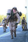 A Marine carries a simulated casualty to safety during a training exercise held by 2nd Maintenance Battalion, 2nd Marine Logistics Group aboard Camp Lejeune, N.C., March 27, 2013. The battalion equipped its Marines with the Multiple Integrated Laser Engagement System, which used lasers to simulate live ammunition during the event. 