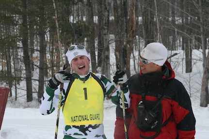 Senior Airman Grant Webber of the Vermont National Guard recovers after finishing the relay race at the 2007 Chief of the National Guard Bureau Biathlon Championships held Feb 18-24 at the Ethan Allen Firing Range in Jericho, Vt., while coach Travis Voyer looks on. Eighteen states sent teams to the championships with a total of about 60 skiers participating.