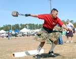 Staff Sgt. Rich Chamberlain of the 1st Battalion, 265th Air Defense Artillery Regiment, prepares to toss a 56-pound. weight for distance during the North East Florida Scottish Games and Festival in Green Cove Springs, Fla., Feb. 24. Chamberlain, shown in a custom-made camouflage kilt, was part of a Florida Army National Guard team competing in the traditional Scottish games. Although this was Chamberlain's first competition, he finished first in his class for the 56-pound weight throw.