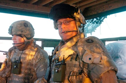 Spc. Stephen Perry of Plymouth, Minn., (left) and Sgt. Scott Stroud of Dalton, Minn., both of Company B, 2nd Combined Arms Battalion, 136th Infantry Regiment, pause as they watch the sun rise Feb. 9 as they stand guard in one of the towers at a combat outpost near Camp Fallujah. Stroud is the only 1st Brigade Combat Team, 34th Infantry Division, soldier to earn Purple Hearts during Operation Iraqi Freedom 06-08.