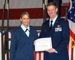 Staff Sgt. Ashley Schmidt, 180th Fighter Wing, receives an award from Col Mark Bartman, 180th FW commander, for leading the Air National Guard in the Guard Recruiting Assistance Program (G-RAP) enlistments since the program began in April 2006. The program is designed for military members who want to volunteer to become recruiting assistants.