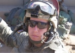 Spc. James Black, a combat medic formerly attached to the Lincoln, Neb.-based 1st Squadron, 167th Cavalry Regiment, poses for a photo while preparing for a convoy mission.