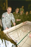 New York Army National Guard Col. Geoffrey Slack, the G-3 (Operations) officer of the 42nd "Rainbow" Infantry Division, reviews the scheme of maneuver for Bright Star 07 over a "sand table." Egyptian and American officers held a planning conference for Bright Star in New York City March 23-27, 2007. Bright Star is an annual Joint / Combined exercise held in Egypt for the last 25 years; this year it will be held Nov. 3-19. 2007 marks the first time a National Guard division will be the tactical headquarters for U.S. forces employed in Bright Star.