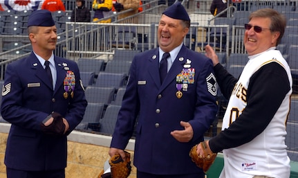 Tech. Sgt. Jeff Myers and, Senior Master Sgt. Don Koch Purple Heart and Bronze Star recipients from Operation Iraqi Freedom, eagerly accept first-pitch advice from longtime Pittsburgh Pirates fan John Wray. Wray, 56, who had been to 50-straight Pirates home openers, loaned the glove he wore as a 6-year old to Sergeant Koch for the opening catch.