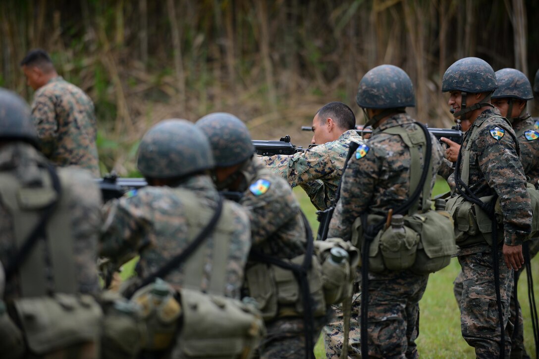 Marine Corps Sergeant Oscar Lopez, Southern Partnership Station Marine detachment,  demonstrates how to properly hold a Galil rifle to the Guatemalan 2nd Brigade Infantry as part of  SPS 2013. The SPS is a 4th Fleet initiative designed to strengthen civil and maritime capabilities with regional partner nations in the Caribbean and Central and South America. (U.S. Air Force photo by Staff Sgt. Ashley Hyatt/Released) 