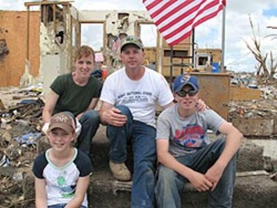 Laura and Rodney Prosser with their daughter Heidi, 11, and son Keith, 13, sit in front of what remains of their Greensburg, Kan., home after it was destroyed by a category F5E tornado, May 4, 2007.