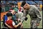 Commander of the 53rd Infantry Brigade Combat Team Brig. Gen. John Perryman (right) greets Sgt. 1st Class Steve Holloway and his son Stevie before the Tampa Bay Devils-Florida Marlins baseball game at Tropicana Field in St. Petersburg, Fla., May 20, 2007. The general administered the Oath of Enlistment to 54 new Soldiers, and Holloway threw out the ceremonial first pitch of the game.