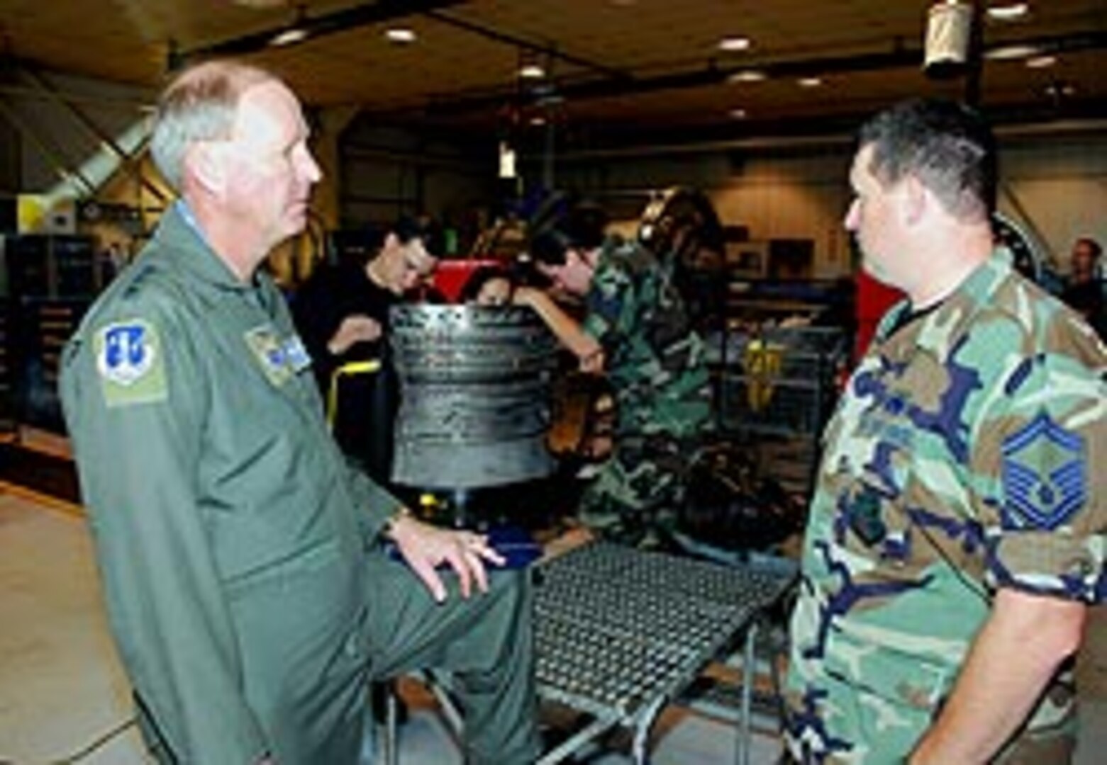 Lt. Gen. Craig R. McKinley, director of the Air National Guard, discusses F-16 Fighting Falcon engine maintenance and repair operations with Senior Master Sgt. Troy Davis, noncommissioned officer in charge of the propulsion branch, while visiting the 181st Fighter Wing, Terre Haute, Ind., on May 18.